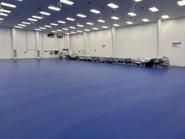 Finished blue industrial flooring in a manufacturing facility