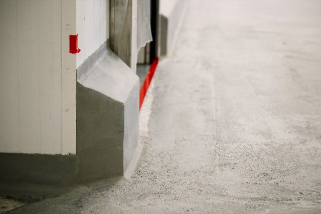 Newly formed cove-base transitions beside a prepared industrial concrete slab